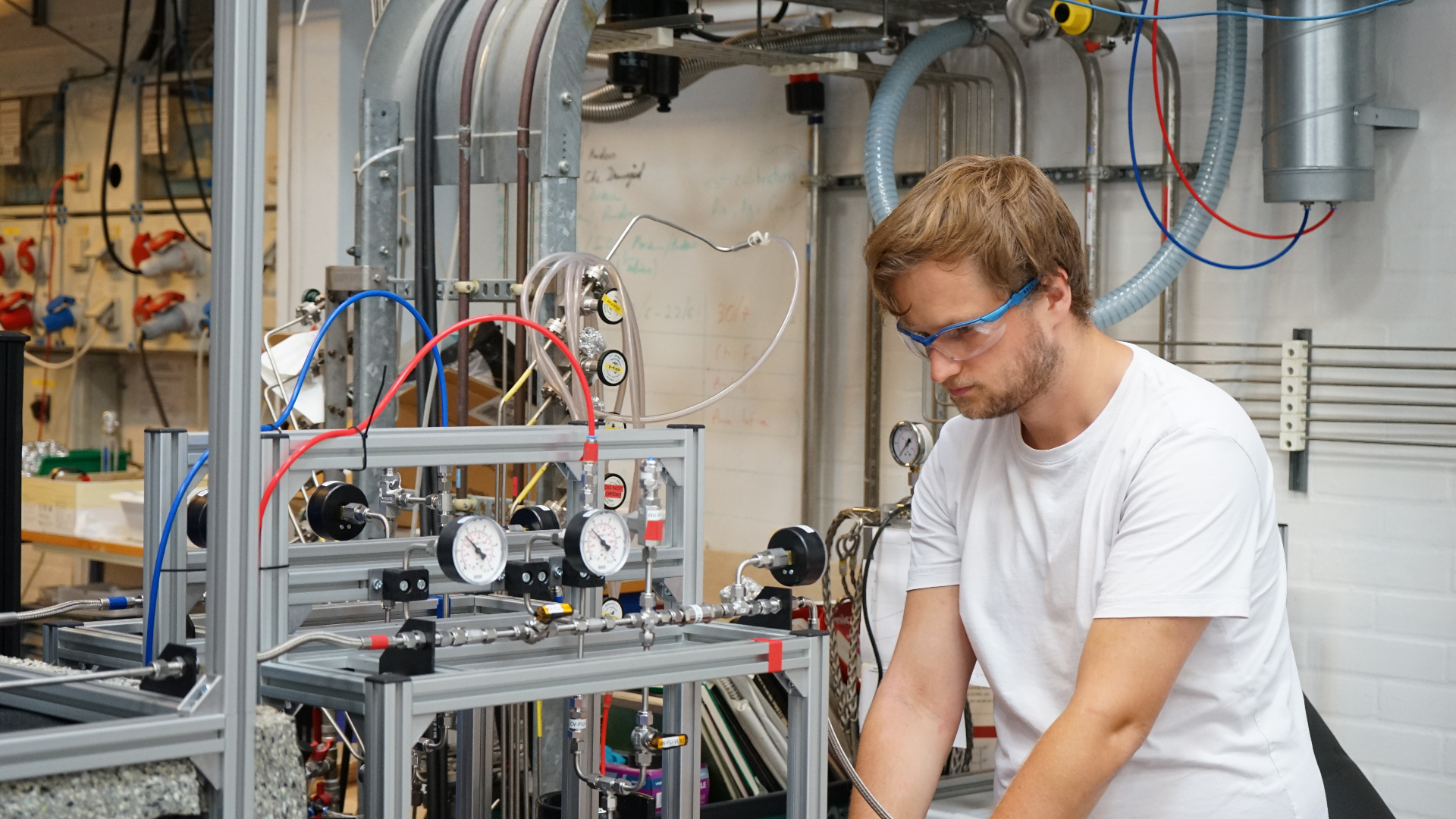Engineer calibrating pressure test apparatus in-house